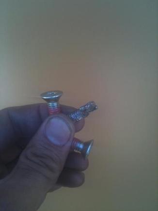 this is what was left of the bolt that was rattling around in my primary for a few states. and the replacements ones. total damage:that new Baker tranny rod, the clutch basket, my new Barnett clutches....... i was not happy. again, Alabama Biker Supply, Huntsville, Alabama......