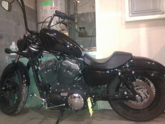 Side shot of the new shocks, blacked out tank and relocation of the stock license bracket. Rewired it back through so the led still works.