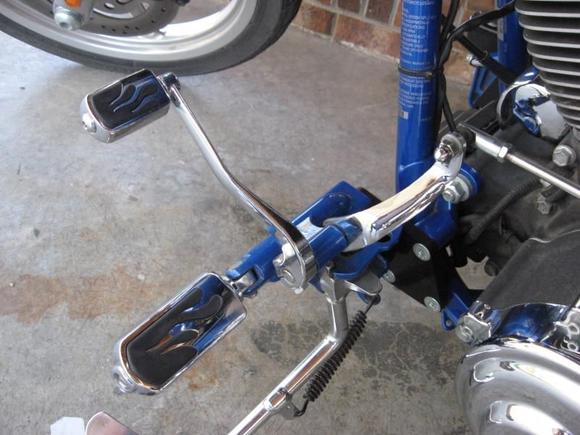 Forward control extension, with flame footpeg and shifter peg.