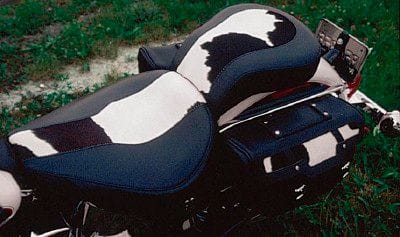 Black,white &amp; brown cow hide inserts on the seats and the
saddlebags was standard on this 1993 year.  In 1994 the
same inserts were used except in black cow hide.  The backrest,tank panel and windshield bag was also offered with
the cowhide inserts.