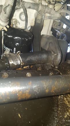 How do i replace this hose? It obviously looks bad to me. You can see where i tried to stop the leak with a worm clamp but failed. I don't want to take the oil pan off even though it needs a pan gasket...