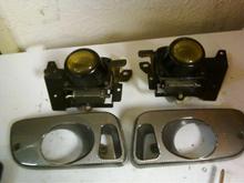 eg fog lights... purchased for $20 from a guy here locally... drilled out all the striped screws, sanded the frame work, and light surrounds and painted them all flat black.... new bulbs... and this was the new state of them before install.