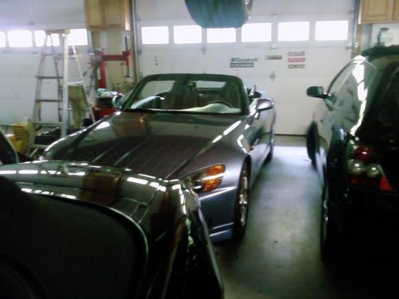 blue s2000 with insignia dual exhaust and you can see the back of the 06 civic si hatch to the right