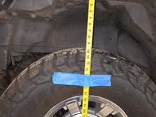 ~10" between top of tire and bottom of fender flare. 