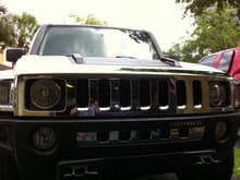 front end showing hood handles and lower grill