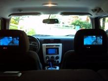 tvs in the headrests and a pioneer navigation screen