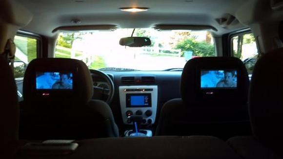 tvs in the headrests and a pioneer navigation screen