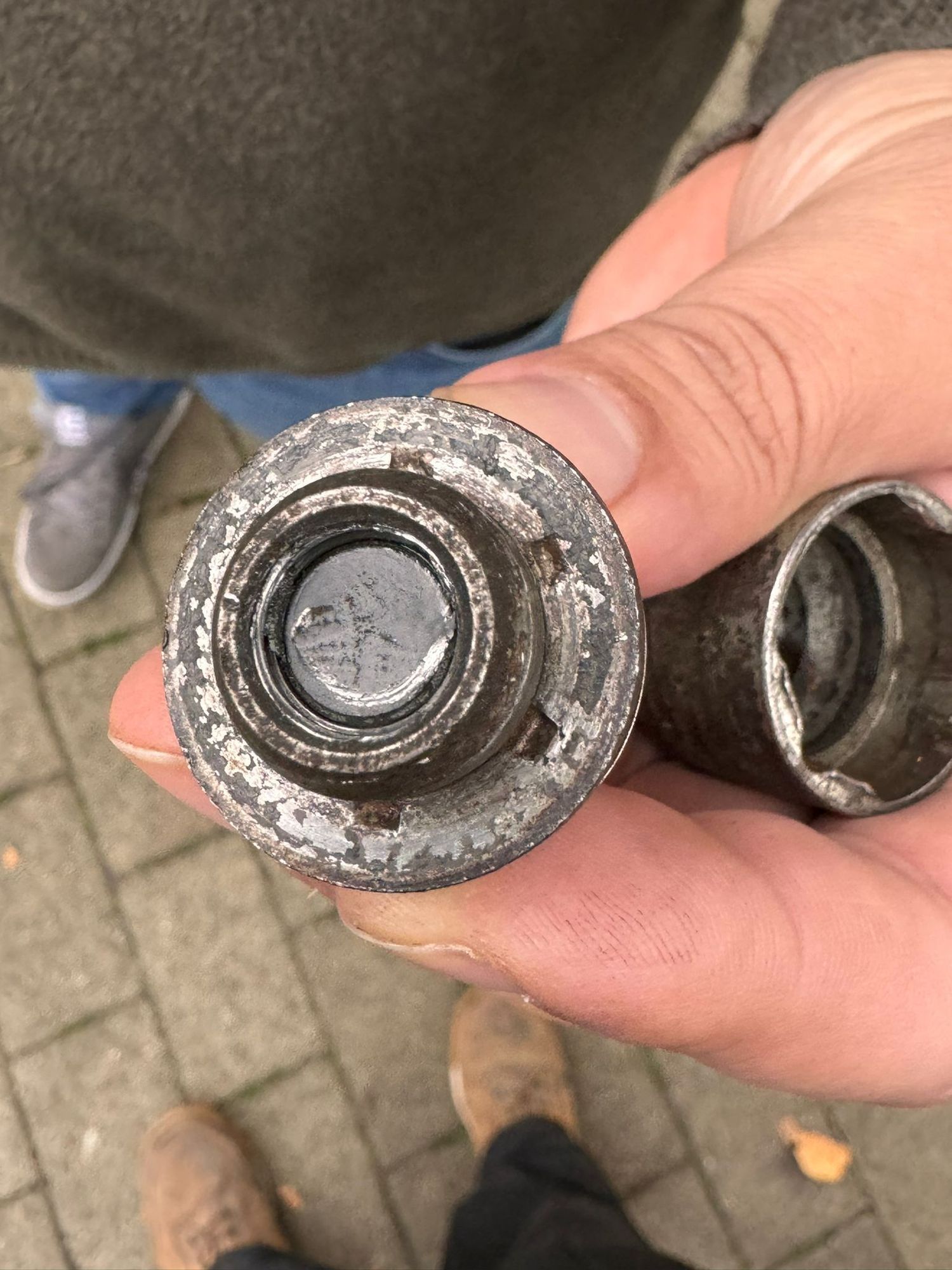 Thread part left inside nut. looks like only the clean silver bit was holding it on. 