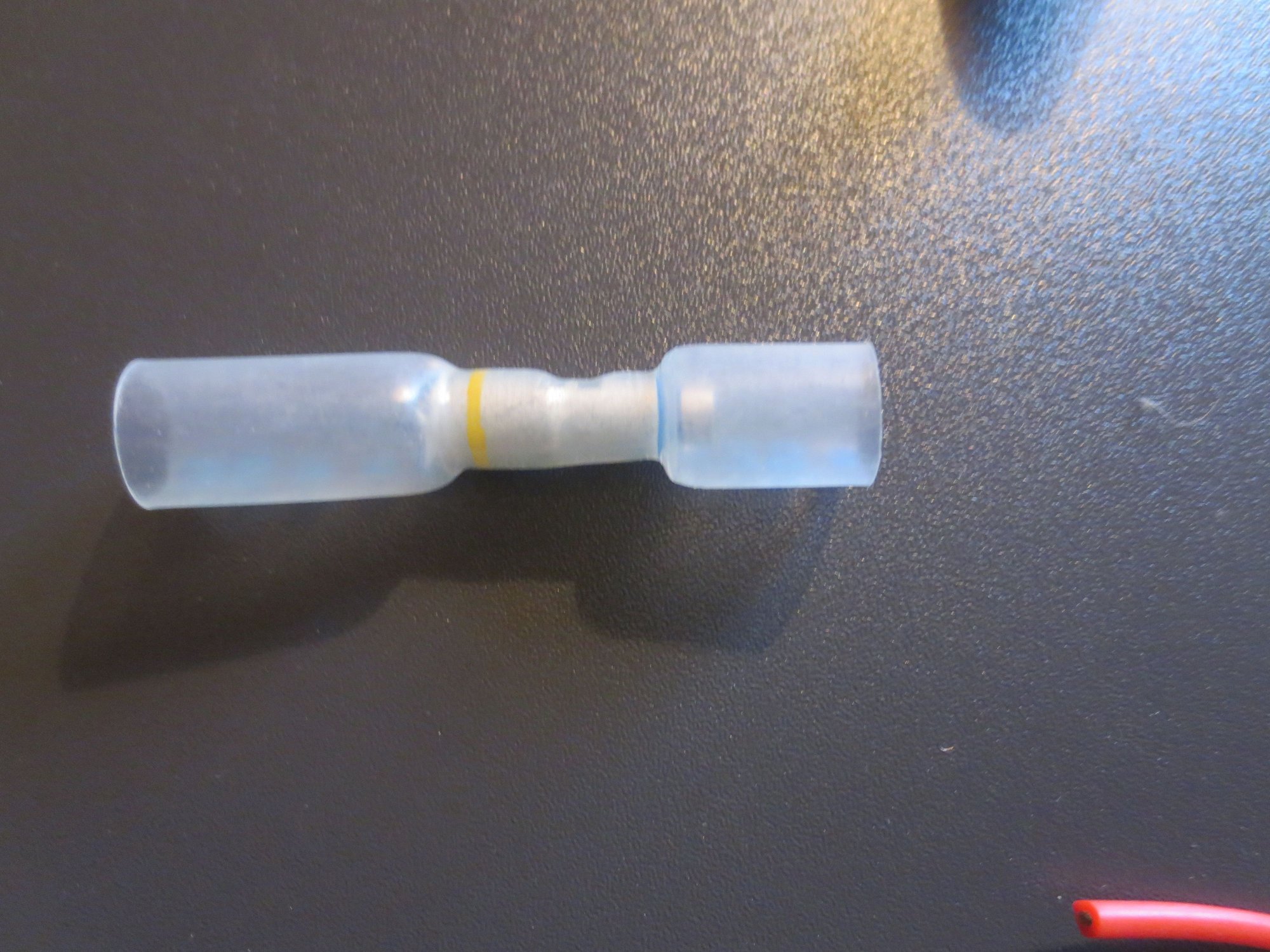 Step down crimp connector, with heat shrink outer. In fact I used a second smaller heat shrink tube inside the Anchor one, as the silicone wires were quite thin and this gave extra grip