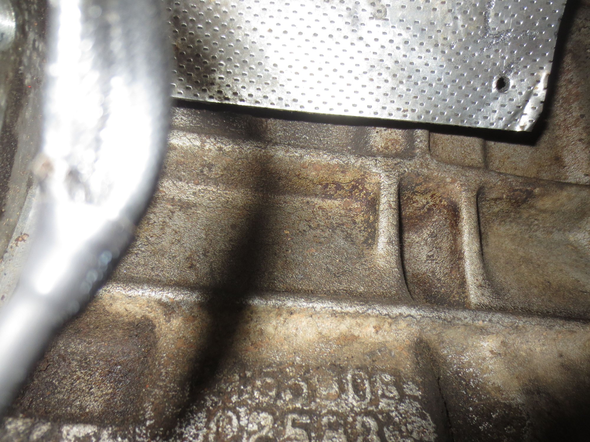 Engine side of the heatshield. The bottom edge is about level with the top of the bottom barrel of the starter.