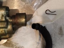 Elbow for fluid going into pump and retaining pin.