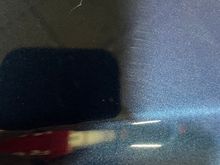 Have to zoom in and they look like a V or a Y There are maybe 12 of these marks on the bonnet.
