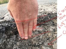 my fingers on the edge of the second pot hole which shows 4" deep at the edge! it was around 6 to 8 inches deep in the middle.