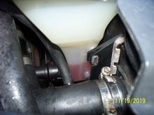 and top radiator hose is still  tight, tank showing low level