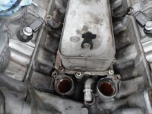 The black clip seen sitting on top of the engine oil cooler fits between the cooler and the flange seen on the tube.  The C2Z18658 short black plastic tube plugs into the port on the back of the water pump and slides over the the metal tube seen here.