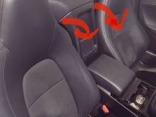 Since no one has answered yet …….Just pull forward from the top. Just non breakable clips here where  the arrows are. Once top is loose just lift the entire panel upwards as sits on some vertically oriented pins at the base. 