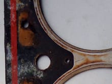 Similar discoloration on bottom of head gasket around cylinder three sealing surface.