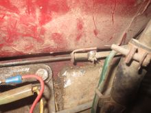 Bowden cable outer anchored to the body on the RHS of the firewall.