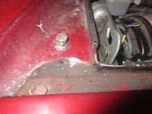 THis is the adjustable bonnet stop in the gutter below the scuttle. OEM it has a rubber cover, but is is hard to tell if the bonnet is contacting this or not. I recommend foam rubber stuck on the bonnet which is a more forgiving material, and it shows up if the stop is toughing it or not.