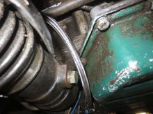Hose emerging from the LHS and curving up across the subframe