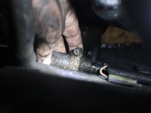 Draining off the Old Antifreeze from the Small Tube. Just undo that Clip and Slide the Tube off