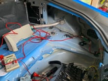 After removing the trim from the trunk I ran the red 8 gauge 12V power wire along the right side. I did not Dynamat anything back here