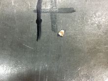 three guesses - two marks and a pilot hole.  Welder made the big "X" a couple of years ago,  I made the other marks on Monday this week.  Shifter ended up left and to the rear of the parks