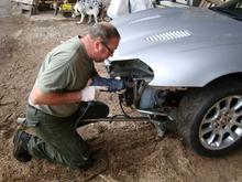 Installing new headlamps. Brackets where damaged in crash.