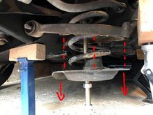 decompressing front coil spring by detaching and  lowering the spring pan