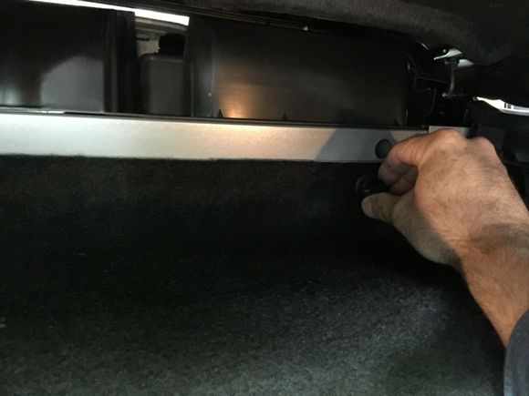 1. Close the top, open the trunk and remove the windowshade cover. Then remove the four plastic wing nuts that hold the trunk wall in place.