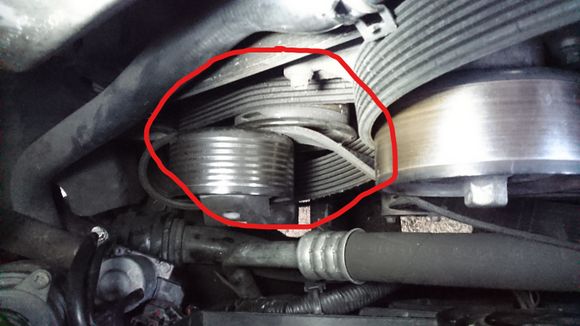 Supercharger tensioner pulley sits right in front (alternator?) pulley. No room for belt removal.
