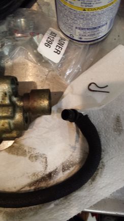 Elbow for fluid going into pump and retaining pin.