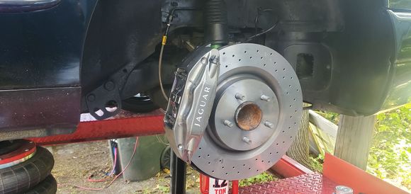 The hose connection is the same as stock, install rotor and caliper

*not pictured but to swap the front dust sheilds you remove 3 bolts and have to pop the lower ball joint as the lower tab is sandwiched there. I also popped off the tie rod to make that easier. You can modify stock front plates but it's better to swap them if you can. 