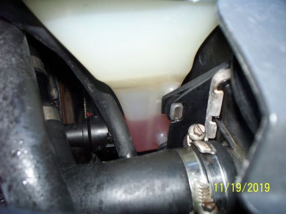 and top radiator hose is still  tight, tank showing low level