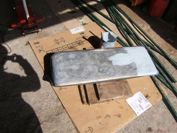 Half painted radiator solder covered fuel tank bottom.