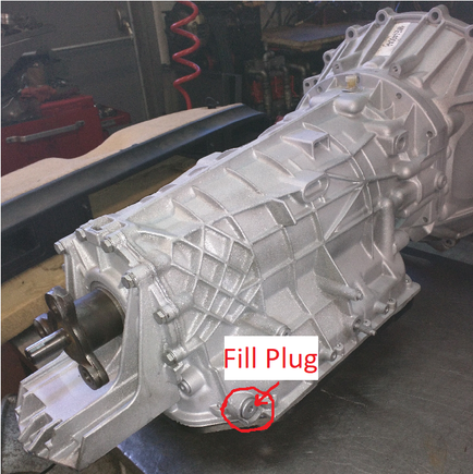 Fill plug located on the back right of the transmission