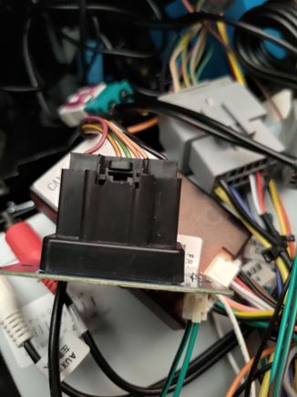 The black connector up front is the harness from the car, going to the connection of the head unit.   Disconnecting and reconnecting the small connector with the black and green wire, will turn the hazard lights on.  Then doing it again will turn them off.   