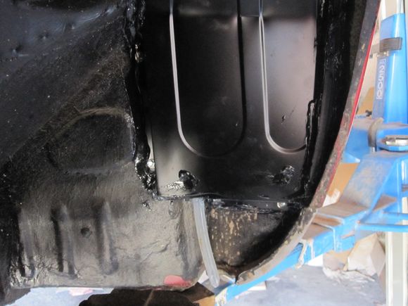 drain emerges from bottom of wheelarch baffle
