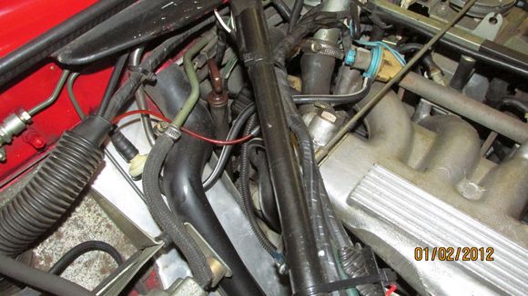 I "think" the vac tube comes out of the large rubber tube on the left side of the photo, goes into a "filter" and then connects at the manifold end.