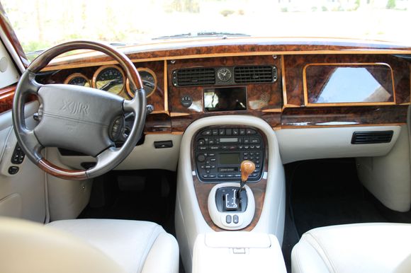 The center face-level vents are fed directly from the heat exchanger housing, while defroster, footwell and rear vents are ducted.  Blowers are housed behind the outboard footwell covers.