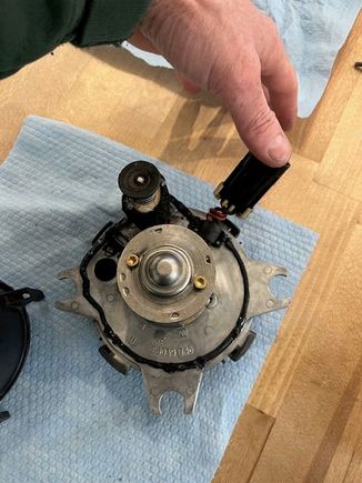 CAREFULLY laying a bead of sealant in the groove on the metal bracket