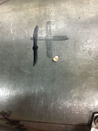 three guesses - two marks and a pilot hole.  Welder made the big "X" a couple of years ago,  I made the other marks on Monday this week.  Shifter ended up left and to the rear of the parks