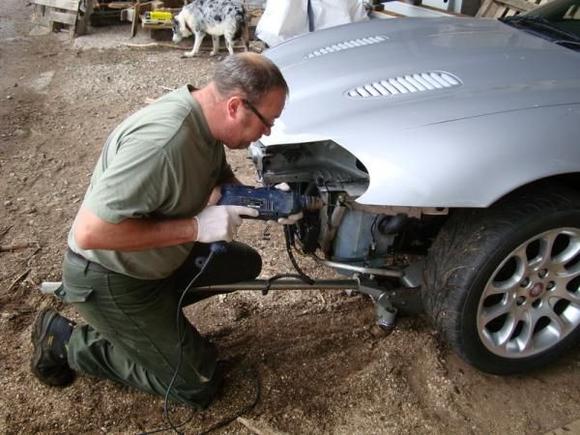 Installing new headlamps. Brackets where damaged in crash.