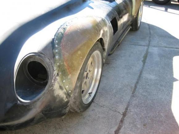 10
Now the front fenders are epoxied and screwed onto the body.  the extra wide shape is starting to become evident and the car is already looking much more agressive.