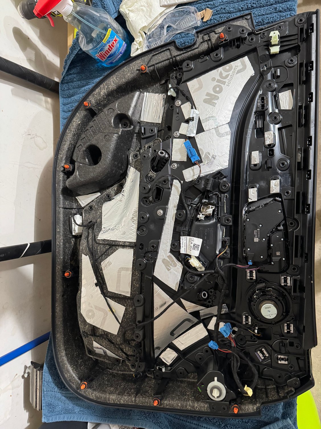 Door panel with sound deadening mat and window weld applied