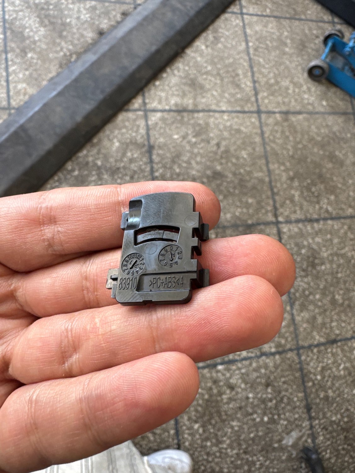 latch holding the pin at the back of the tray cover