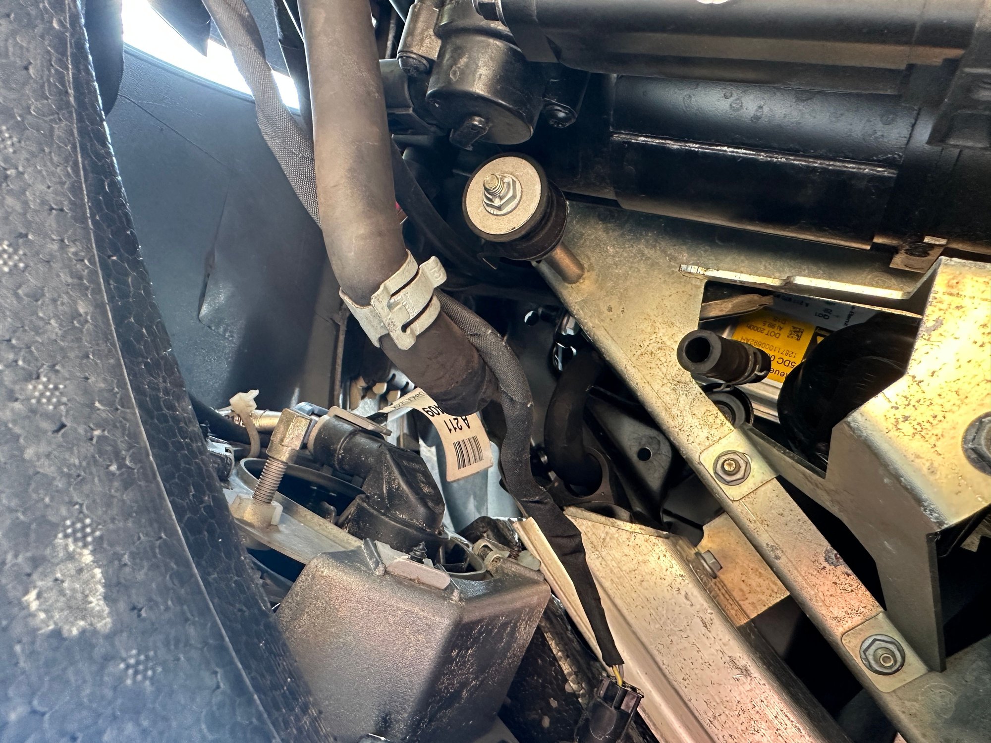 Close-up view of the Airmatic air pump area, showing the air filter and attached hose at the bottom.