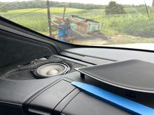 Passenger side.  Use plastic pry tool and work from inside edge to pry up and pop out that speaker grille.  Pry old speaker up and disconnect its plug.