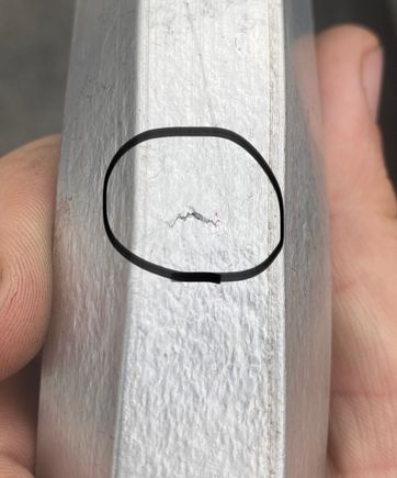 You can see in this picture that when these parts were in the shop press to add the required clearance angle, it looks like they were heated far past the point of being annealed.  Circled is a tear in the aluminum grain structure.  I plan on welding this crack before I install these on my car. 