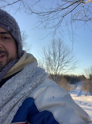 At the end of a snowshoe trek, dying from lack of sleep and cold but almost home. The road to my neighborhood is seen. 